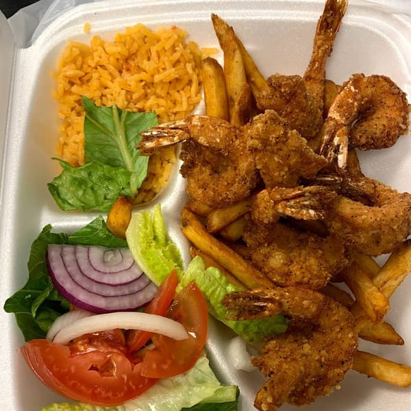 Sabor Maya Mexican Cuisine's fried shrimp with french fries, rice, and a side salad.