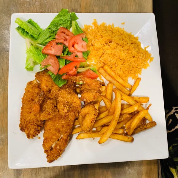 A Sabor Maya Mexican Cuisine plate with fried fish, shrimp, french fries, rice, and a side salad.